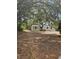 Charming single-story home with neutral siding and mature trees offering shade and curb appeal at 8255 Richmond St, Gibsonton, FL 33534