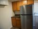 Compact kitchen featuring wood cabinets, dark countertops, and stainless steel refrigerator at 8255 Richmond St, Gibsonton, FL 33534