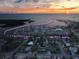 An aerial view of the coastal community with a sunset, highlighting the residences and waterfront access at 8304 Aquila St, Port Richey, FL 34668