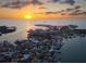 Stunning aerial view of waterfront community at sunset, highlighting the home's desirable location at 8304 Aquila St, Port Richey, FL 34668