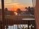 Stunning sunset from a waterfront balcony with palm trees and serene water views at 8304 Aquila St, Port Richey, FL 34668