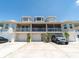 Three-story exterior showcasing garages, balconies, and well-maintained facade of the townhome at 8304 Aquila St, Port Richey, FL 34668