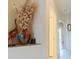 This hallway features artistic decorations, including a giraffe sculpture and a colorful vase with decorative plants at 8304 Aquila St, Port Richey, FL 34668