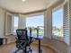 Bright home office with large windows and a modern adjustable standing desk and chair at 8304 Aquila St, Port Richey, FL 34668