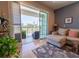 Bright living room featuring a balcony with sliding glass doors and neutral-toned sectional sofa at 8304 Aquila St, Port Richey, FL 34668