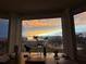 Cozy desk setup with a bay window view, capturing a colorful sky and neighborhood scenery at 8304 Aquila St, Port Richey, FL 34668