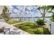 Backyard patio featuring a waterfront view and lush landscaping at 8635 Boca Ciega Dr, St Pete Beach, FL 33706