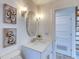 Bathroom featuring a vanity with a decorative mirror and modern lighting fixtures at 8635 Boca Ciega Dr, St Pete Beach, FL 33706