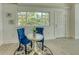 Bright dining area featuring a round table, blue chairs, and a view of the outdoors at 8635 Boca Ciega Dr, St Pete Beach, FL 33706