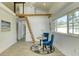 Cozy dining area with a vaulted ceiling, wood floors, and a unique loft ladder at 8635 Boca Ciega Dr, St Pete Beach, FL 33706