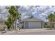 Home exterior showcasing a spacious two-car garage and well-maintained landscaping at 8635 Boca Ciega Dr, St Pete Beach, FL 33706
