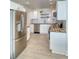 Modern kitchen with stainless steel appliances, white cabinets, and tile floors at 8635 Boca Ciega Dr, St Pete Beach, FL 33706