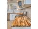 Kitchen counter with butcher block countertops, white cabinets, and stainless-steel appliances at 8635 Boca Ciega Dr, St Pete Beach, FL 33706