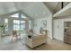 Bright living room with large windows offering stunning water views and modern furnishings at 8635 Boca Ciega Dr, St Pete Beach, FL 33706