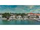 Waterfront view of several houses, showcasing docks, lush trees, and beautiful views at 8635 Boca Ciega Dr, St Pete Beach, FL 33706