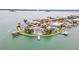 An aerial view of a waterfront home with a pool and a dock on a point at 892 Harbor Is, Clearwater Beach, FL 33767