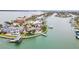 An aerial view of a waterfront home with a pool and a dock on a point at 892 Harbor Is, Clearwater Beach, FL 33767