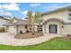 Two story home with tile roof and stone driveway, landscaped yard and covered front entry at 892 Harbor Is, Clearwater Beach, FL 33767