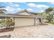Two story home with tile roof and stone driveway, landscaped yard and two car garage at 892 Harbor Is, Clearwater Beach, FL 33767