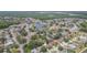 Overhead view of homes in a neighborhood near lakes, lush greenspaces, and roadways at 9112 Calle Alta, New Port Richey, FL 34655