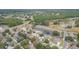 Aerial view of a neighborhood featuring homes near a pond, green spaces, and a highway at 9112 Calle Alta, New Port Richey, FL 34655