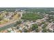 Aerial view of a suburban community with mature trees, ponds, and roadways at 9112 Calle Alta, New Port Richey, FL 34655