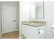 Bright bathroom featuring granite countertop vanity, undermount sink, framed mirror, and a white paneled door at 9112 Calle Alta, New Port Richey, FL 34655