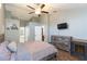 Comfortable bedroom featuring a ceiling fan, hardwood floors and a television at 9112 Calle Alta, New Port Richey, FL 34655