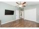 Spacious bedroom with wood floors, ceiling fan, and ample closet space at 9112 Calle Alta, New Port Richey, FL 34655