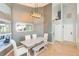 Bright dining room features white furniture set and modern light fixture at 9112 Calle Alta, New Port Richey, FL 34655