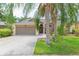 Charming single-Gathering home with a two-car garage, well-maintained lawn, and mature palm trees at 9112 Calle Alta, New Port Richey, FL 34655