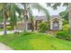 Attractive single-Gathering house boasting lush landscaping and a well-manicured lawn at 9112 Calle Alta, New Port Richey, FL 34655