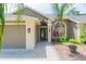 Inviting home featuring a brick walkway, a two-car garage, and beautiful landscaping at 9112 Calle Alta, New Port Richey, FL 34655