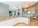 Open concept kitchen with granite countertops and white cabinets connects to dining area at 9112 Calle Alta, New Port Richey, FL 34655