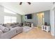 Comfortable living room with vaulted ceiling, neutral tones, and large television at 9112 Calle Alta, New Port Richey, FL 34655