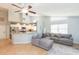 Open-concept living room with kitchen bar and comfortable gray sofa at 9112 Calle Alta, New Port Richey, FL 34655