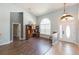 Open living room with wood floors, large window, and stylish decor at 9112 Calle Alta, New Port Richey, FL 34655