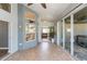 Large enclosed sunroom leads to dining area, living room, and patio at 9112 Calle Alta, New Port Richey, FL 34655