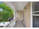 Relaxing balcony with wood floors, white railing, and a view of mature trees at 923 Lumsden Reserve Dr, Brandon, FL 33511