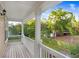 Inviting balcony with wood floors, white columns, and a view of a lush backyard at 923 Lumsden Reserve Dr, Brandon, FL 33511
