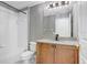Stylish bathroom with a tub, white tiled walls, and a vanity with granite countertop at 923 Lumsden Reserve Dr, Brandon, FL 33511