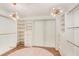 Luxury closet featuring custom shelves, hardwood floor and stunning chandeliers at 923 Lumsden Reserve Dr, Brandon, FL 33511