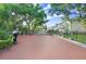 Gated community entrance featuring brick pillars, a wrought iron gate, and manicured landscaping at 923 Lumsden Reserve Dr, Brandon, FL 33511