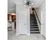 Bright entryway with modern light fixture and staircase at 923 Lumsden Reserve Dr, Brandon, FL 33511