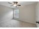 Inviting bedroom featuring soft carpet, a bright window, a ceiling fan, and closet at 9403 N 13Th St, Tampa, FL 33612
