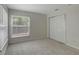 Bright bedroom with carpet flooring and a large window at 9403 N 13Th St, Tampa, FL 33612