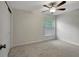 Comfortable carpeted bedroom featuring a window and ceiling fan at 9403 N 13Th St, Tampa, FL 33612
