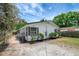 A view of the corner lot property with freshly landscaped exterior and vibrant green foliage at 9403 N 13Th St, Tampa, FL 33612