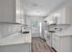Bright kitchen featuring white cabinets, quartz countertops, and stainless steel appliances at 9403 N 13Th St, Tampa, FL 33612