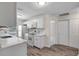 Modern kitchen with white cabinets, quartz counters, stainless steel appliances, and hardwood flooring at 9403 N 13Th St, Tampa, FL 33612